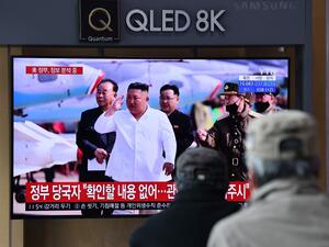 People watch a television news broadcast showing file footage of North Korean leader Kim Jong Un, at a railway station in Seoul on April 21, 2020. South Korea played down a report on April 21 that the North's leader Kim Jong Un was being treated after surgery, as speculation mounted over his absence from a key anniversary. Jung Yeon-je / AFP