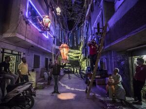 Egyptian youths decorate their residential street in preparation for the Muslim holy month of Ramadan in Cairo's Hadayek el-Maadi district, on April 21, 2020. From cancelled iftar feasts to suspended mosque prayers, Muslims across the Middle East are bracing for a bleak month of Ramadan fasting as the threat of the COVID-19 pandemic lingers. Ramadan is a period for both self-reflection and socialising. Believers fast from dawn to dusk and then gather around a family or community meal each evening of Islam's