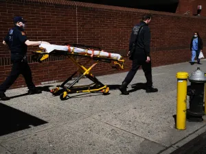 Medical workers walk with a stretcher outside of Montefiore Medical Center April 06, 2020 in the Bronx borough of New York City. AFP