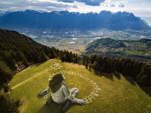 "Beyond crisis", his new work on a clearing in the Swiss resort town of Leysin, shows a girl sitting, completing a chain of stick figures holding hands.(Twitter)