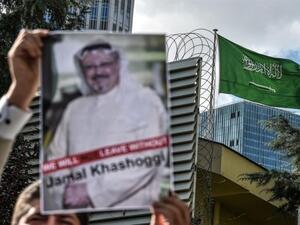 A demonstrator outside the Saudi consulate in Istanbul holds up an image of Jamal Khashoggi (AFP)