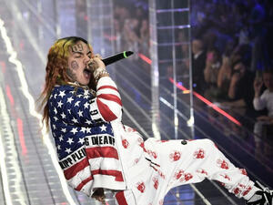 In this file photo taken on September 21, 2018 US rapper Tekashi 6ix9ine performs during the Philipp Plein fashion showw as part of the Women's Spring/Summer 2019 fashion week in Milan. MARCO BERTORELLO / AFP via Getty Images