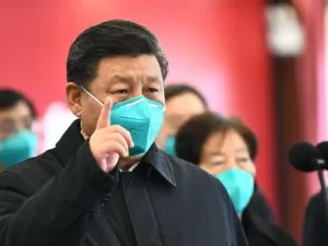 Chinese President Xi Jinping gestures to a coronavirus patient and medical staff via a video link at the Huoshenshan hospital in Wuhan on Tuesday. Photograph: Xie Huanchi/Xinhua/AFP via Getty Images