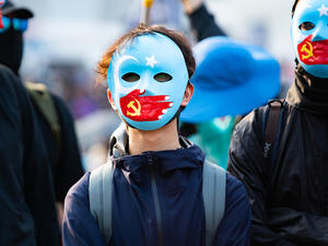 Hong Kong protestors wear masks symbolizing the Communist Party of China's silencing of Uyghur Muslims at a solidarity rally at Edinburgh Place, central Hong Kong. (Shutterstock/ File Photo)