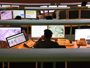 Police officers monitor the streets and receive calls from citizens at the Command and Control Center of Dubai Police in the Gulf emirate, on February 24, 2020. The novel coronavirus has given the Gulf emirate of Dubai an opportunity to showcase its technological and scientific clout as it seeks to shape its own model for approaching the pandemic. KARIM SAHIB / AFP