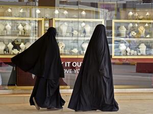 Saudi women walk past jewellers at the Tiba gold market in the capital Riyadh on April 30, 2020, after the partial lifting of the curfew. FAYEZ NURELDINE / AFP