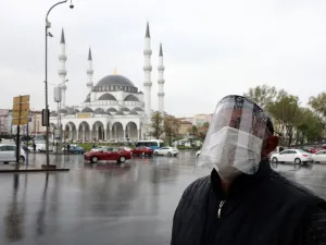 A man wearing a face-shield for protective measures crosses the streets as the spread of the COVID-19, the novel coronavirus continues in Ankara, on April 30, 2020. Adem ALTAN / AFP