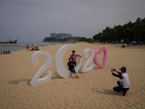 In a photo taken on May 2, 2020 holiday-makers visit a beach in Sokcho, on South Korea's north-east coast during a public holiday long weekend. Ed JONES / AFP