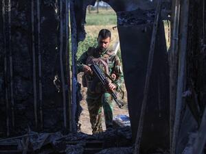 An Iraqi fighter with the Hashed al-Shaabi (Popular Mobilisation Forces) inspects the site of the Islamic State (IS) group attack, a day earlier, on a unit of the paramilitary force in Mukaishefah, about 180km (110 miles) north of the capital, on May 3, 2020. IS group remnants in Iraq are exploiting a coronavirus lockdown, coalition troop withdrawals and simmering political disputes to ramp up deadly attacks, according to analysts and intelligence officials, the bloodiest so far being an ambush early on May
