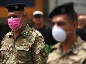 Members of the Iraqi security forces wearing protective masks keep watch at Tahrir Square in central Baghdad on May 5, 2020 during of the Muslim holy month of Ramadan after authorities eased up the lockdown measures that they had imposed in a bid to slow the spread of the novel coronavirus Covid-19. AHMAD AL-RUBAYE / AFP