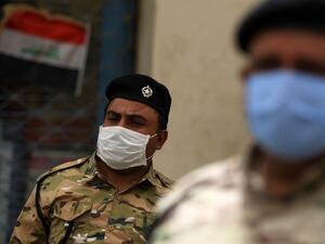 Members of the Iraqi security forces wearing a protective masks and gloves stand guard in the capital Baghdad's Tahrir square on May 5, 2020, during the novel coronavirus pandemic crisis. (AFP/File)