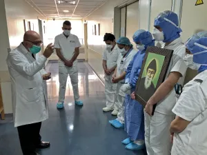 A picture taken by a nurse on April 9, 2020 at the Hotel Dieu de France Hospital, colleagues gathered for a prayer guided by a priest in the coronavirus COVID-19 section of the hospital, in the neighbourhood of Ashrafieh of the Lebanese capital Beirut's eastern suburbs. (AFP)
