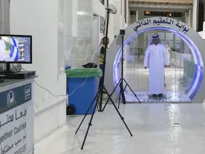 A man passes through a self-sterilisation gate set up at an entrance of the Kaaba and the Grand Mosque, as a preventive measure amid the the COVID-19 pandemic during the Muslim month of Ramadan in the Saudi holy city of Mecca, on May 8, 2020. (STR / AFP)