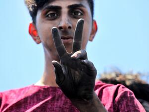 An Iraqi protester gestures as he stands on the Al-Jumhuriyah bridge in the capital Baghdad on May 11, 2020, during an anti-government demonstration. Modest anti-government rallies resumed in some Iraqi cities Sunday, clashing with security forces and ending months of relative calm just days after Prime Minister Mustafa Kadhemi's government came to power. The protests first erupted in Baghdad and Shiite-majority southern cities in October, demanding an end to corruption and unemployment and an overhaul of t