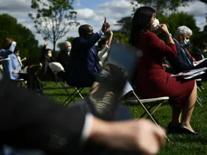 Reporters wearing masks ask questions as US President Donald Trump speaks during a news conference on the novel coronavirus, COVID-19, in the Rose Garden of the White House in Washington, DC on May 11, 2020. Brendan Smialowski / AFP