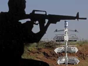 This picture taken on May 12, 2020 from a tourist lookout point at an Israeli army outpost on Mount Bental in the Israeli-annexed Golan Heights shows a directional sign for cities and places across the world and listing their respective distances. JALAA MAREY / AFP