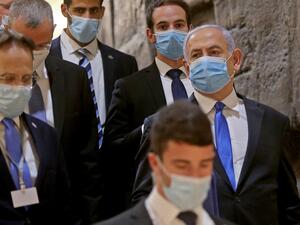 Israeli Prime Minister Benjamin Netanyahu (R), wearing a protective face mask, arrives for the swearing-in ceremony at Israel's parliament, the Knesset, in Jerusalem on May 17, 2020 As Israel was set to launch its new unity government Sunday, Prime Minister Benjamin Netanyahu vowed to push on with controversial plans to annex large parts of the occupied West Bank. POOL / AFP