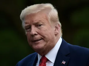 US President Donald Trump walks across the South Lawn upon his return to the White House in Washington, DC on May 27, 2020. SpaceX's landmark launch to the International Space Station -- the first crewed mission to blast off from US soil in almost a decade -- was scrubbed today due to bad weather. Olivier DOULIERY / AFP