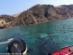 Alexandr Yemchenko, one of the men in the video, turns the video on himself and his companion and says:  'Killer whales, friends, these were real killer whales.' (Alexandr Yemchenko)