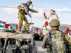 A Palestinian protester yells at an Israeli soldier during a protest in a residential area near the Palestinian village of Naqura, north-west of Nablus in the occupied West Bank, September 4. (AFP)