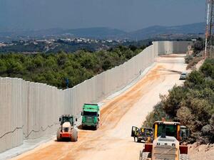 Near the Rosh Hanikra border crossing in northern Israel, shows tractors along a new wall on the Israeli-Lebanese border. AFP