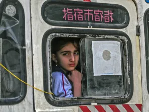 A girl looks from out the window of a vehicle leaving the town of Sarmin in Syria's northwestern Idib province, headed towards the border with Turkey, on March 10, 2020. Ozan KOSE / AFP