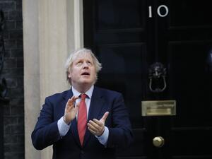 Britain's Prime Minister Boris Johnson participates in a national "clap for carers" to show thanks for the work of Britain's NHS (National Health Service) workers and other frontline medical staff around the country as they battle with the novel coronavirus pandemic, outside 10 Downing Street in London on May 28, 2020. Tolga AKMEN / AFP
