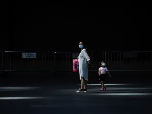 A woman and a child wearing face mask walk out of a mall in Beijing on June 2, 2020. WANG ZHAO / AFP