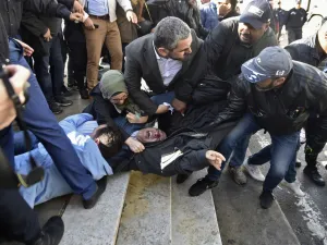 In this file photo taken on February 28, 2019, Samir Benlarbi (C), an Algerian opposition figure of the "Hirak" movement, tries to stop plain clothes policemen from detaining a protester participating in a rally organised by journalists against alleged censorship of coverage of protests against a fifth term for veteran President Abdelaziz Bouteflika in Algiers. Karim Tabbou and Samir Benlarbi, two of the main figures of Algeria's "Hirak" protest movement, will soon be freed under presidential pardons, said 