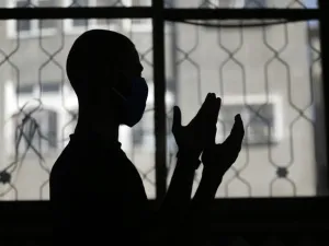 A mask-clad Palestinian man takes part in the noon (Dhuhr) prayers at the Al-Abrar mosque in Rafah in the sothern Gaza Strip on June 3, 2020, after local authorities who had shut down mosques due to the coronavirus allowed them to reaopen. SAID KHATIB / AFP