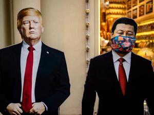 Cardboard figures of Chinese President Xi Jinping (R) wearing a face mask and US President Donald Trump (L) stand in front of a souvenir shop in downtown Moscow on June 3, 2020. (Dimitar DILKOFF / AFP)