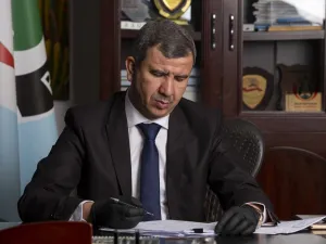 Newly-appointed Iraqi Minister of Oil Ihsan Ismaeel reads documents at the Basra Oil Company in Iraq's southern port city, on May 9, 2020. Hussein FALEH / AFP