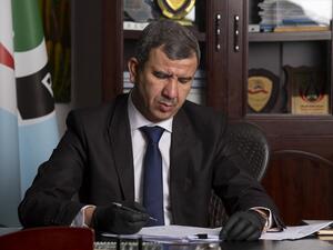 Newly-appointed Iraqi Minister of Oil Ihsan Ismaeel reads documents at the Basra Oil Company in Iraq's southern port city, on May 9, 2020. Hussein FALEH / AFP
