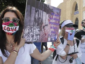 Mask-clad Lebanese protesters take part in a demonstration in central Beirut, on June 6, 2020. Protesters poured into the streets of the Lebanese capital to decry the collapse of the economy, as clashes erupted between supporters and opponents of the Iran-backed Shiite group Hezbollah. ANWAR AMRO / AFP