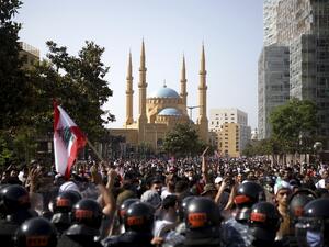 Lebanese riot police stand guard in front of protesters during a demonstration in central Beirut, on June 6, 2020. Protesters poured into the streets of the Lebanese capital to decry the collapse of the economy, as clashes erupted between supporters and opponents of the Iran-backed Shiite group Hezbollah. PATRICK BAZ / AFP