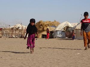  In this file photo taken on May 06, 2020 Children walk past tents at a displaced persons camp in the Khokha district of Yemen's western province of Hodeida. The world is facing an "impending global food emergency" that could impact hundreds of millions of people as the coronavirus pandemic threatens already strained supply chains, UN Secretary-General Antonio Guterres warned Tuesday. Khaled ZIAD / AFP