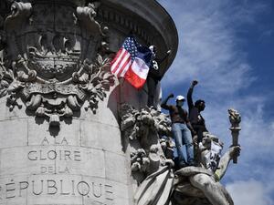 Protesters raise their fist from the statue of Marianne on Place de la Republique in Paris on June 13, 2020, during a rally as part of the 'Black Lives Matter' worldwide protests against racism and police brutality. Anne-Christine POUJOULAT / AFP