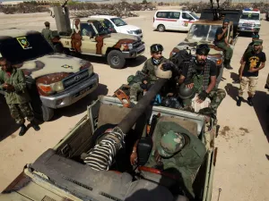 Members of the self-proclaimed eastern Libyan National Army (LNA) special forces gather in the city of Benghazi, on their way to reportedly back up fellow LNA fighters on the frontline west of the city of Sirte, facing forces loyal to the UN-recognised Government of National Accord (GNA), on June 18, 2020. The resurgent GNA has vowed to push on for Sirte, late Libyan leader Moamer Kadhafi's hometown and the last major settlement before the traditional boundary between western Libya and Haftar's stronghold i