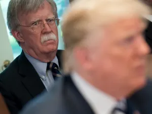 In this file photo US President Donald Trump speaks alongside National Security Adviser John Bolton (L) during a Cabinet Meeting in the Cabinet Room of the White House in Washington, DC, May 9, 2018. Donald Trump said on June 20, 2020 his former national security advisor John Bolton would pay a "big price" for what the president described as an illegal tell-all memoir. SAUL LOEB / AFP