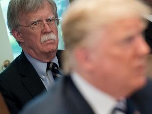In this file photo US President Donald Trump speaks alongside National Security Adviser John Bolton (L) during a Cabinet Meeting in the Cabinet Room of the White House in Washington, DC, May 9, 2018. Donald Trump said on June 20, 2020 his former national security advisor John Bolton would pay a "big price" for what the president described as an illegal tell-all memoir. SAUL LOEB / AFP