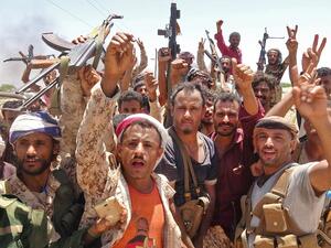 In this file photo taken on May 11, 2020, fighters from of the Southern Transitional Council (STC) gesture following clashes with Saudi-backed government forces in the Sheikh Salim area in the southern Abyan province. On top of war and the coronavirus pandemic, Yemen faces looming economic disaster as a crisis gripping its main benefactor Saudi Arabia dents remittances and leaves state coffers running dry. Nabil HASAN / AFP