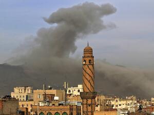 In this file photo taken on June 16, 2020, smoke billows following an airstrike by Saudi-led coalition in the Yemeni capital Sanaa. On top of war and the coronavirus pandemic, Yemen faces looming economic disaster as a crisis gripping its main benefactor Saudi Arabia dents remittances and leaves state coffers running dry. MOHAMMED HUWAIS / AFP
