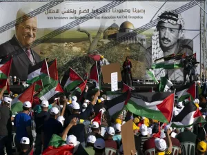Palestinians wave flags during a big rally called by Palestinian Authority's Fatah party to protest against Israel's plan to annex parts of the occupied West Bank, in Jericho on June 22, 2020. Israel intends to annex West Bank settlements and the Jordan Valley, as proposed by US President Donald Trump, with initial steps slated to begin from July 1. ABBAS MOMANI / AFP