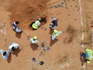 An aerial view shows Libyan experts searching for human remains during the exhumation of mass graves in Tarhuna, southeast of the capital Tripoli, on June 23, 2020. (AFP)