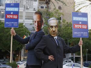 Protesters, wearing masks of Israel's Prime Minister Benjamin Netanyahu and his coalition partner Defence Minister Benny Gantz, take part in a demonstration in Tel Aviv's Rabin Square to denounce Israel's plan to annex parts of the occupied West Bank, on June 23, 2020. Only a week before Netanyahu intends to kick-start annexation plans in the occupied West Bank, Israel's premier is facing challenges at home and abroad. JACK GUEZ / AFP