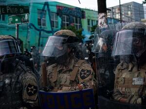 Washington National Guard personnel face off with demonstrators near the Seattle Police Departments East Precinct on June 6, 2020 in Seattle, Washington. This is the 12th day of protests since George Floyd died in Minneapolis police custody on May 25. David Ryder/Getty Images/AFP David Ryder / GETTY IMAGES NORTH AMERICA / Getty Images via AFP