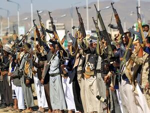 Armed Yemeni men hold their weapons as they gather in the capital Sanaa to show their support to the Houthis. (File/AFP)