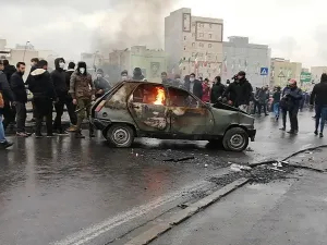 Iranian protesters gather around a burning car during a demonstration against an increase in gasoline prices in the capital Tehran, on November 16, 2019. AFP/Getty Images