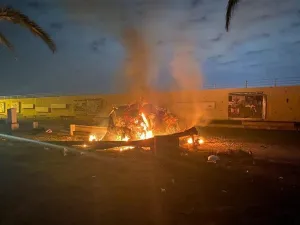 A picture published by the media office of the Iraqi military's joint operations forces on their official Facebook page shows a destroyed vehicle on fire following a US strike on January 3, 2020 on Baghdad international airport road. (File/AFP)