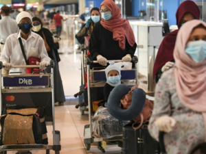 Indian nationals gather at the Dubai International Airport before leaving the country on a flight back to their country, May 7, 2020. /AFP